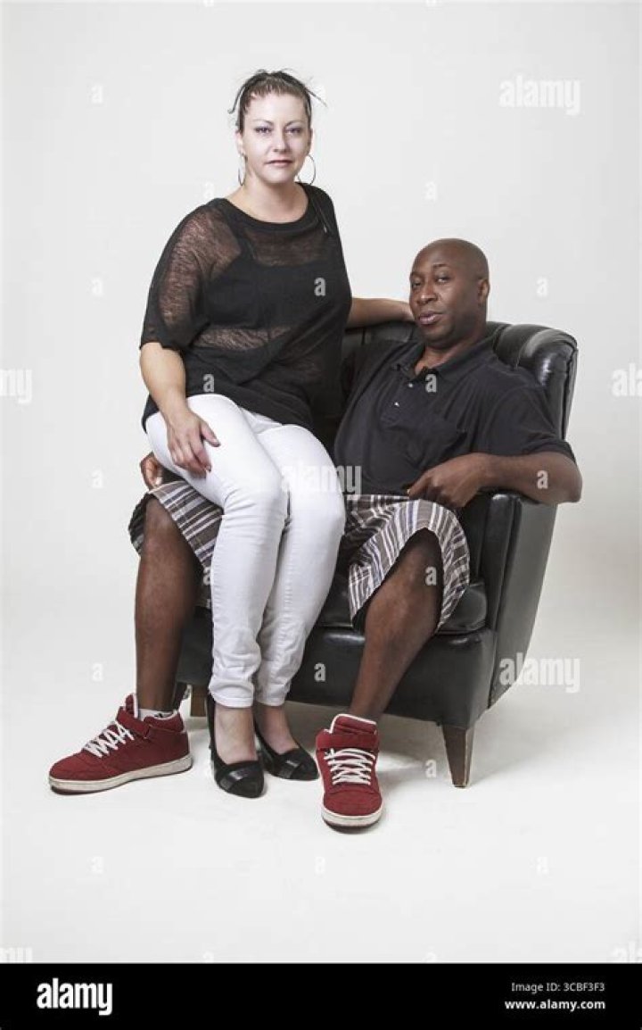 a man and woman sitting next to each other on a window sill