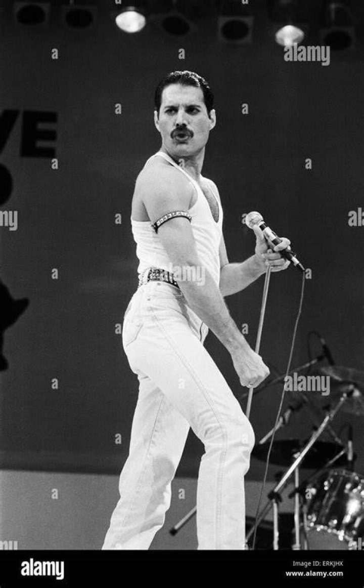 Freddie Mercury, lead singer of British rock group Queen, performing on