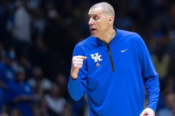 Head coach of the Kentucky Wildcats Rich Brooks looks up at the