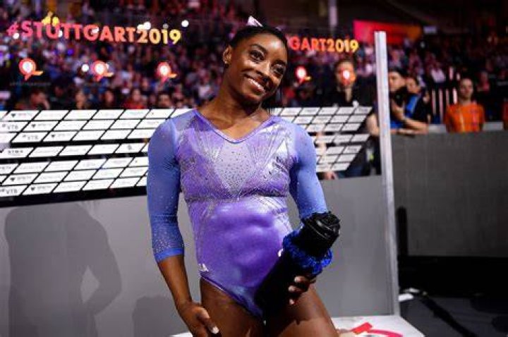 Simone Biles Shows off Her Toned Figure in Cool Snake Print Top and